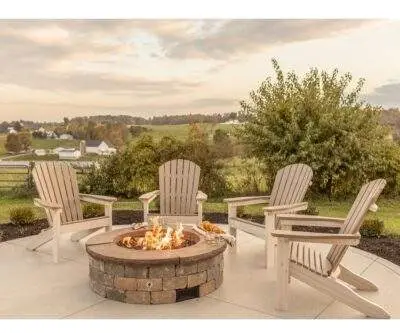two toned muskoka chairs by the fire