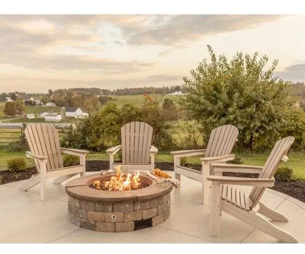 two toned muskoka chairs by the fire