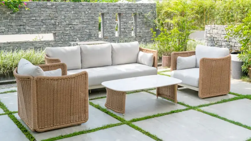outdoor sofa and chairs in a neutral beige wicker